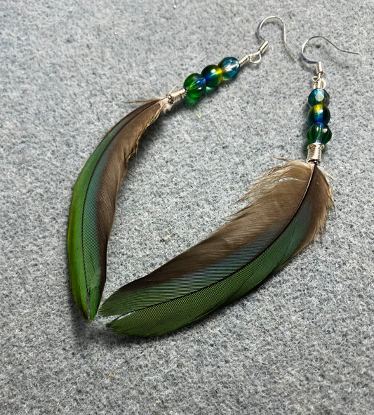 Bluish green mini macaw feather earrings adorned with green and teal Czech glass beads.