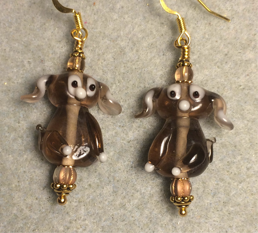 Translucent tan lamp work floppy eared puppy dog bead earrings adorned with tan Czech glass beads.