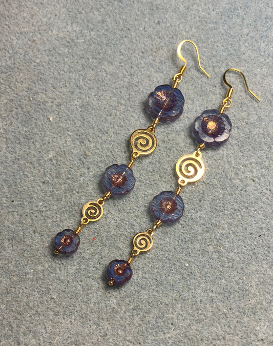 Extra long blue striped flower bead earrings made with three sizes of blue striped Czech glass pansy beads joined by gold swirly connectors.