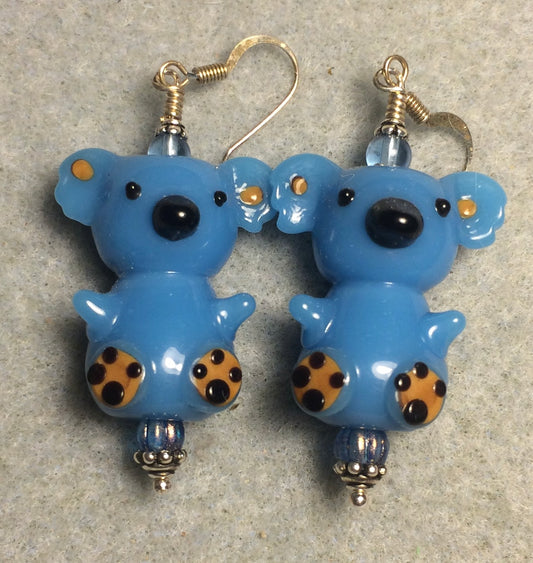 Large blue lamp work koala bear bead earrings adorned with blue Czech glass beads.