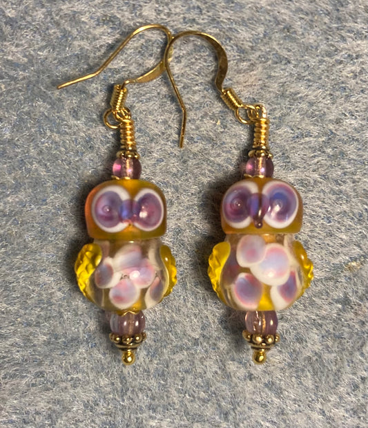 Amber and purple lamp work owl bead earrings adorned with purple Czech glass beads.