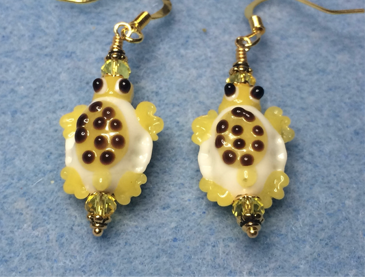 Yellow and white lamp work spotted turtle bead earrings adorned with yellow Chinese crystal beads.