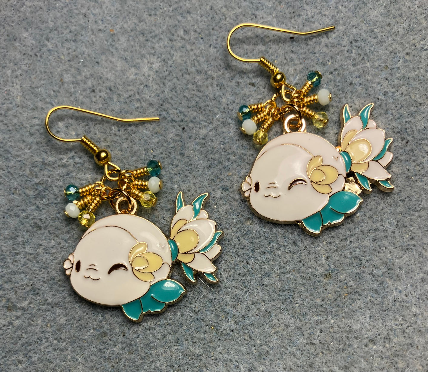Large white, yellow, and turquoise enamel fish charm earrings adorned with tiny dangling white, yellow, and turquoise Chinese crystal beads.