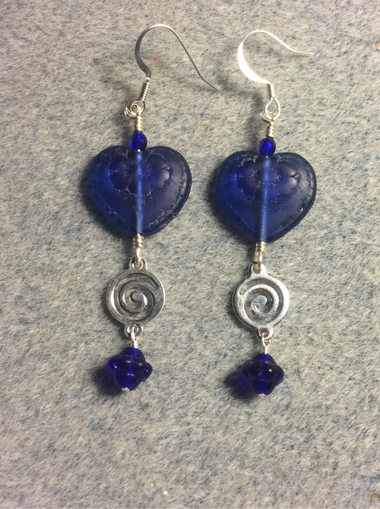 Dark blue Czech glass heart bead earrings adorned with silver swirly links and dark blue Czech glass Saturn beads.