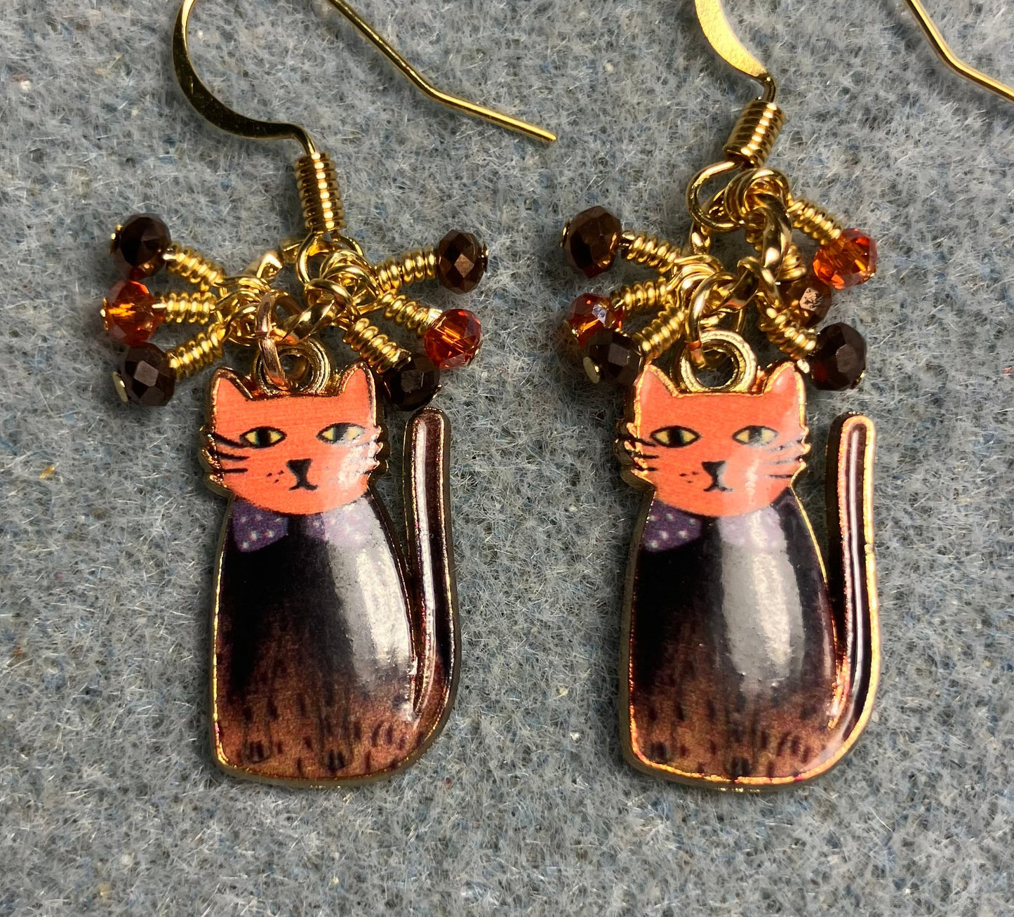 Brown and orange enamel cat charm earrings adorned with tiny dangling brown and orange Chinese crystal beads.