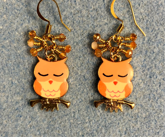 Orange, amber, and peach enamel sleepy owl charm earrings adorned with tiny dangling orange, amber, and peach Chinese crystal beads.