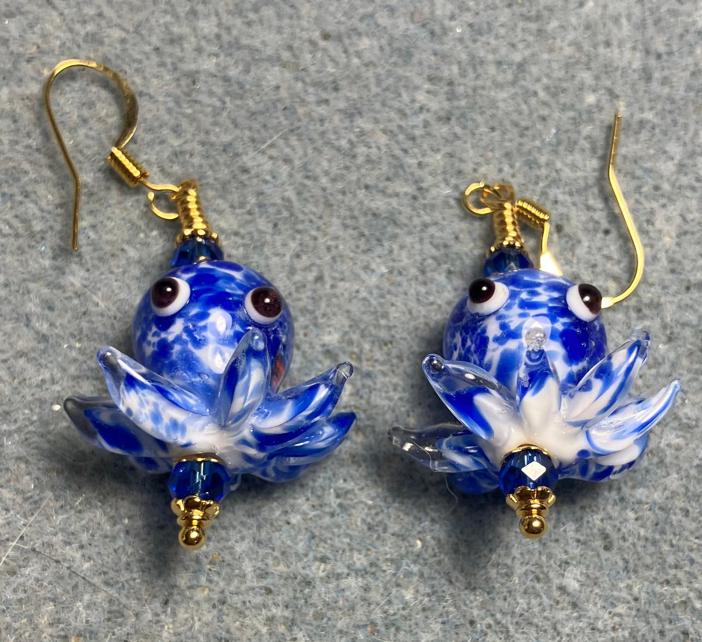 Bright blue and white mottled lamp work octopus bead earrings adorned with bright blue Chinese crystal beads.