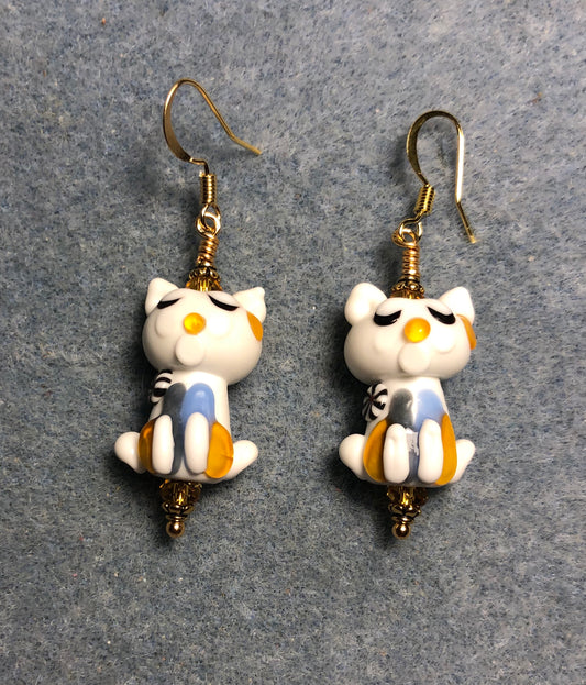 White, light blue, and amber lamp work cat bead earrings adorned with amber Chinese crystal beads.