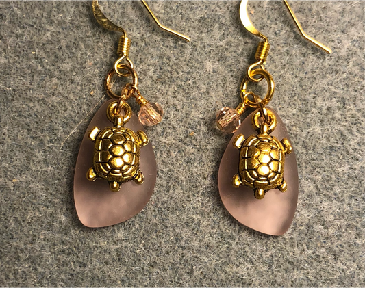 Small rose pink sea glass pendant bead earrings adorned with small gold turtle charms and rose pink Chinese crystal beads.