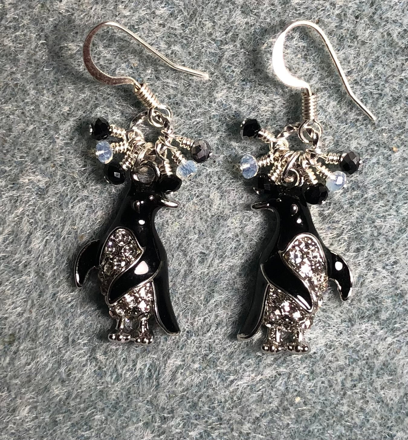 Black and silver enamel and rhinestone penguin charm earrings adorned with tiny dangling black and clear Chinese crystal beads.