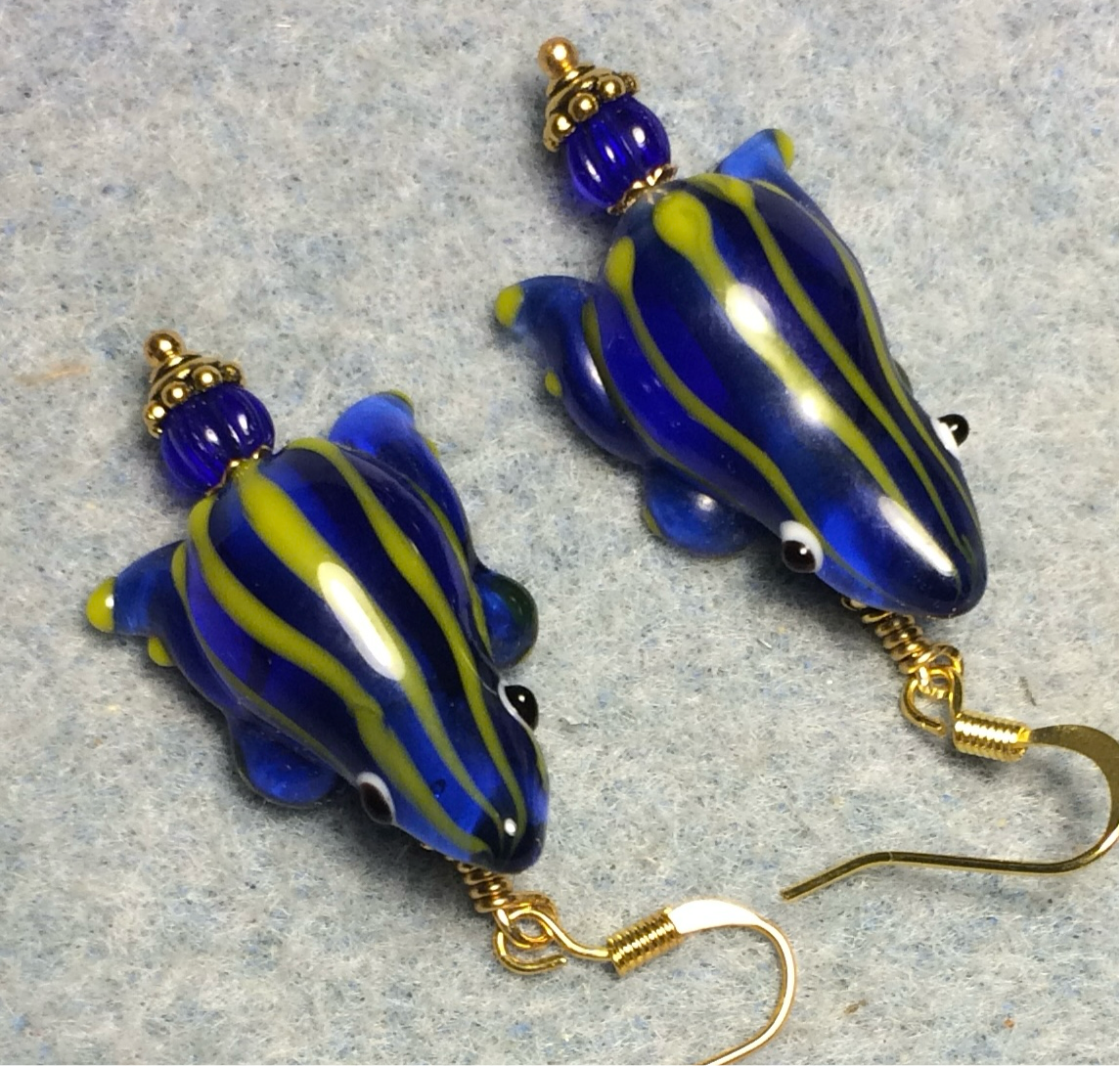 Dark blue with yellow stripes lamp work frog bead earrings adorned with dark blue Czech glass beads.