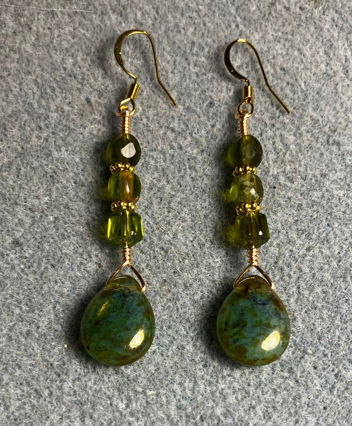 Olive green Czech glass pear drop bead earrings adorned with olive green Czech glass beads.