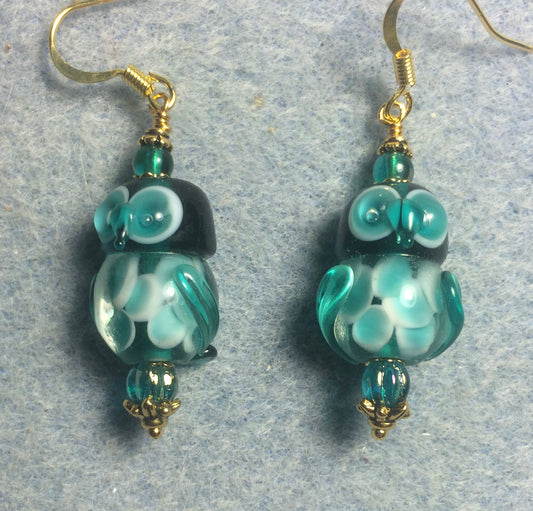 Teal lamp work owl bead earrings adorned with teal Czech glass beads.