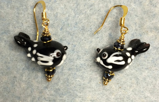 Black and white lamp work flying fish bead earrings adorned with black Chinese crystal beads.