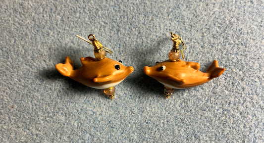 Tan lamp work whale bead earrings adorned with tan Chinese crystal beads.