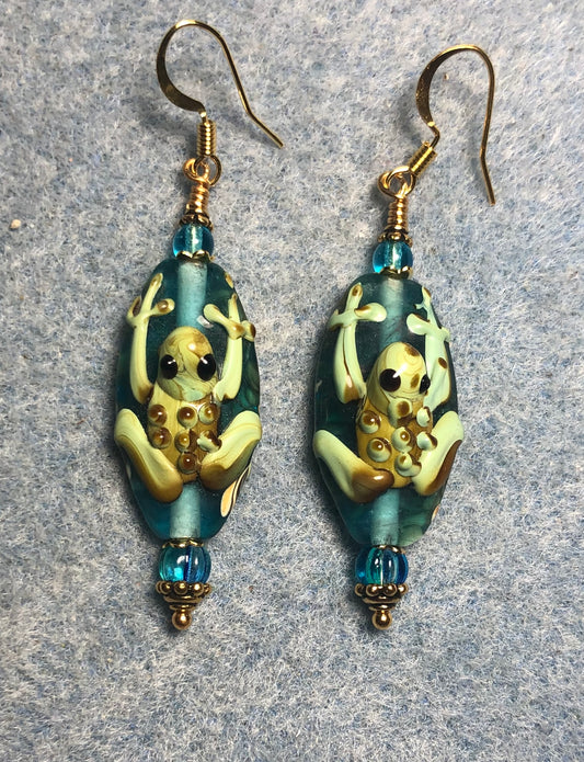 Turquoise and green lamp work frog bead earrings adorned with turquoise Czech glass beads.