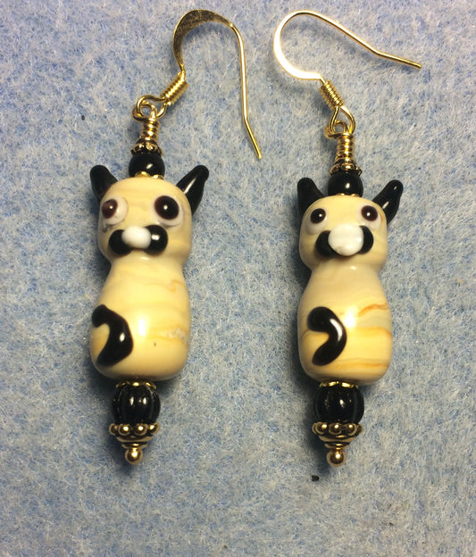 Tan and black lamp work cat bead earrings adorned with black Czech glass beads.