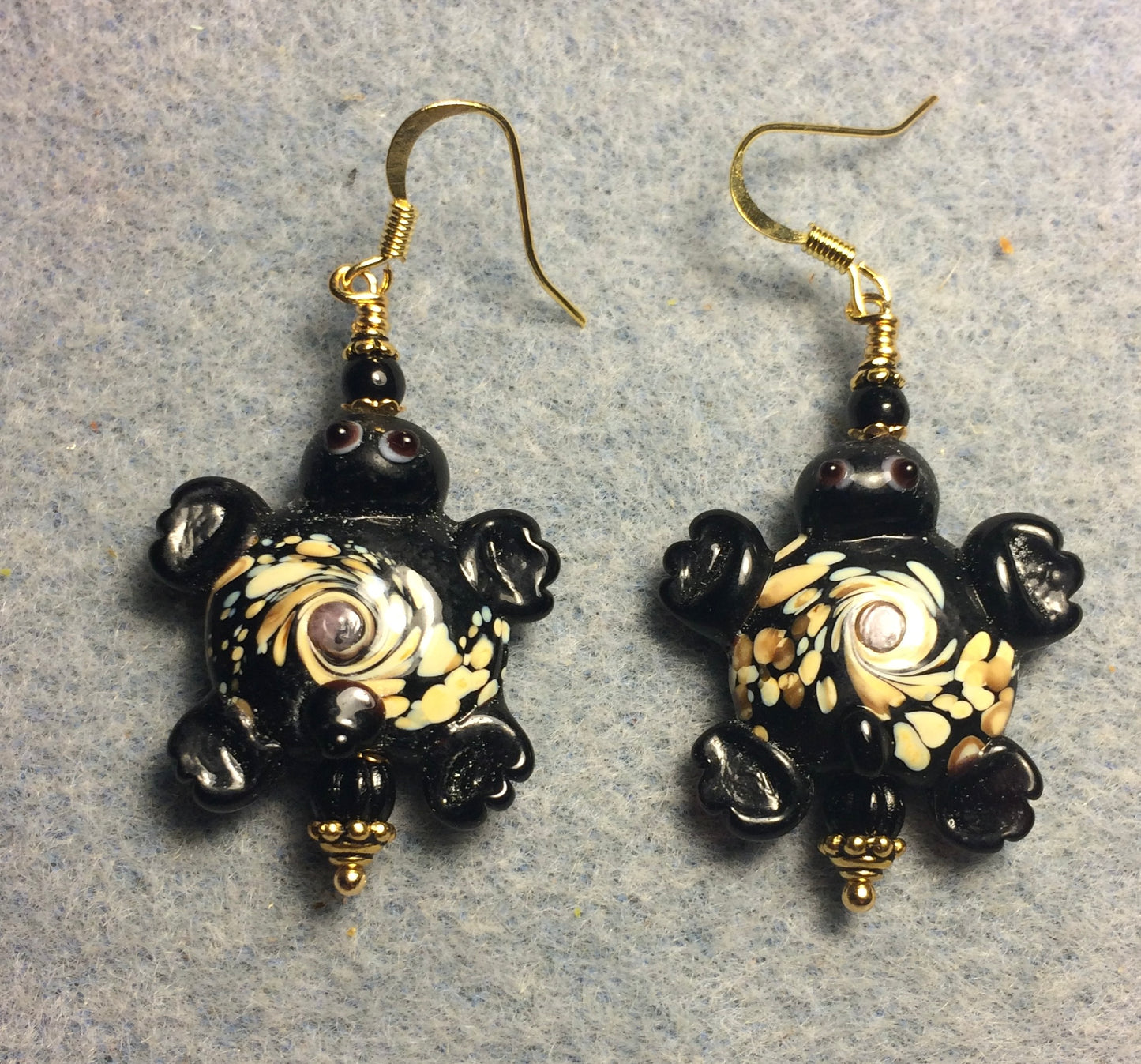 Large black spotted lamp work turtle bead earrings adorned with black Czech glass beads.