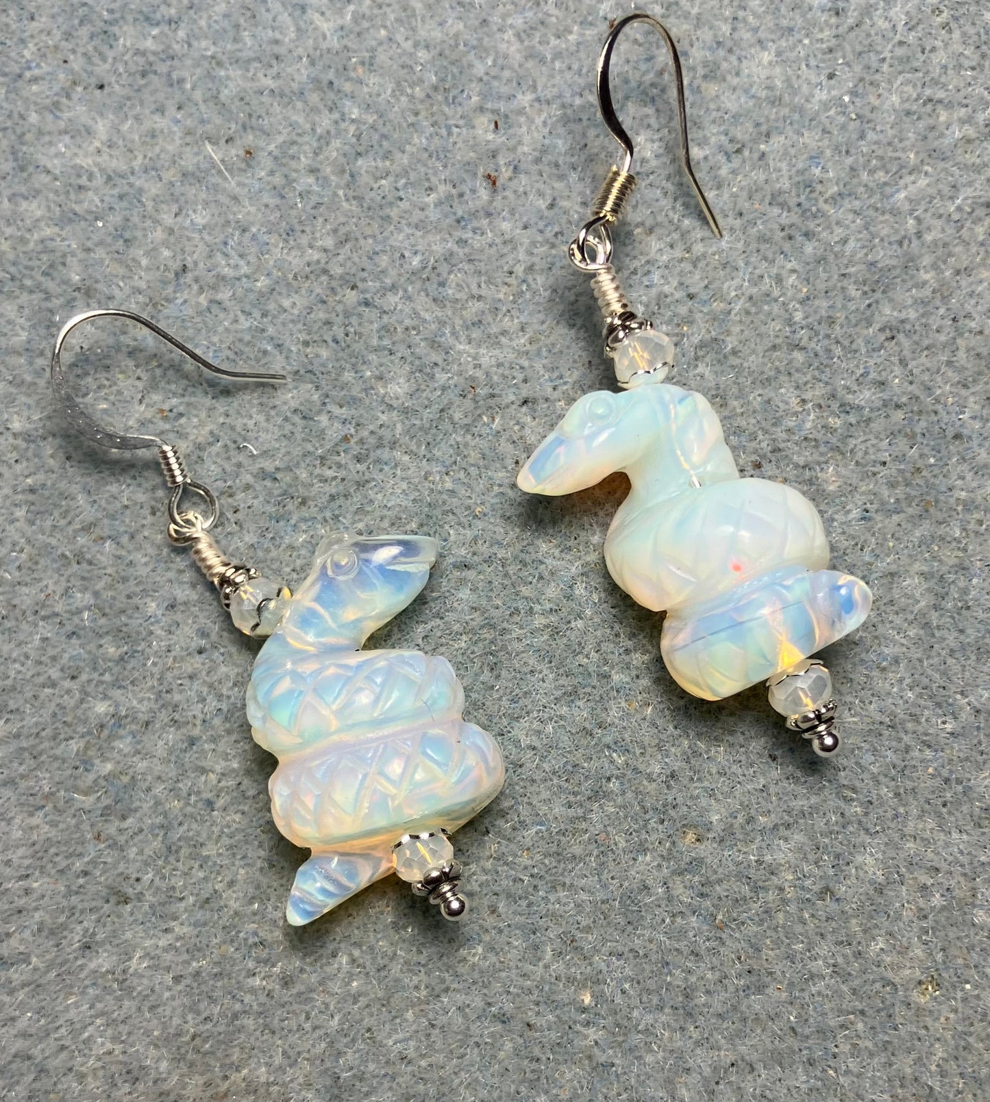 Opalite gemstone coiled snake bead earrings adorned with white Chinese crystal beads.