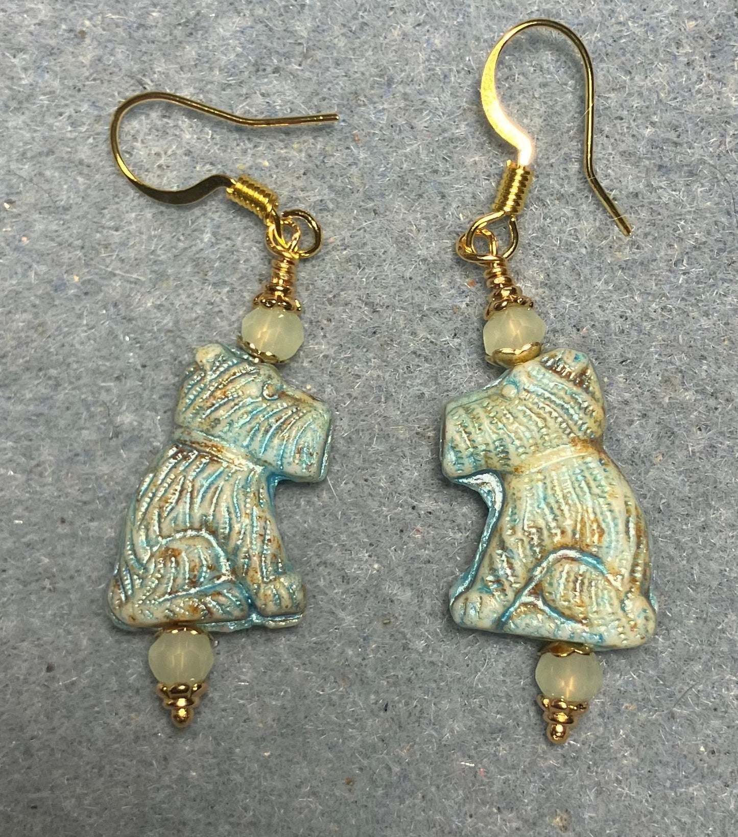 Light green Czech glass Schnauzer bead earrings adorned with light green Chinese crystal beads.
