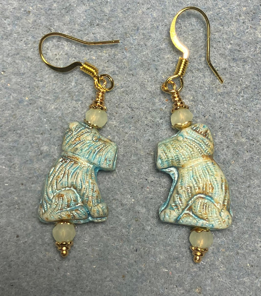 Light green Czech glass Schnauzer bead earrings adorned with light green Chinese crystal beads.