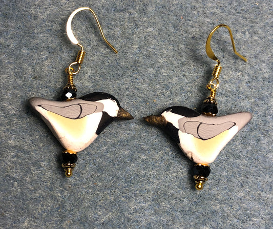 White, tan, and black polymer clay bird bead earrings adorned with black Chinese crystal beads.