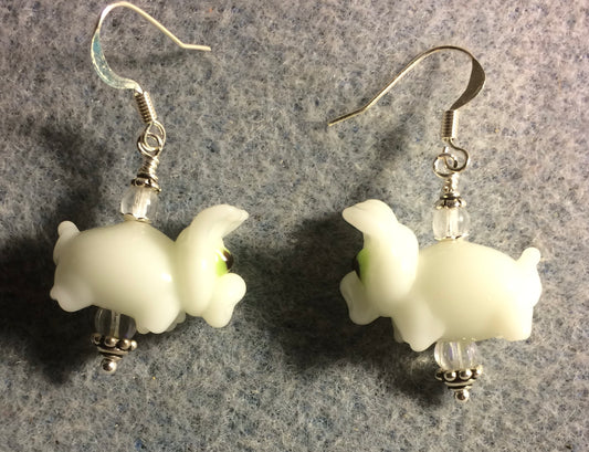White lamp work pig bead earrings adorned with clear Czech glass beads.