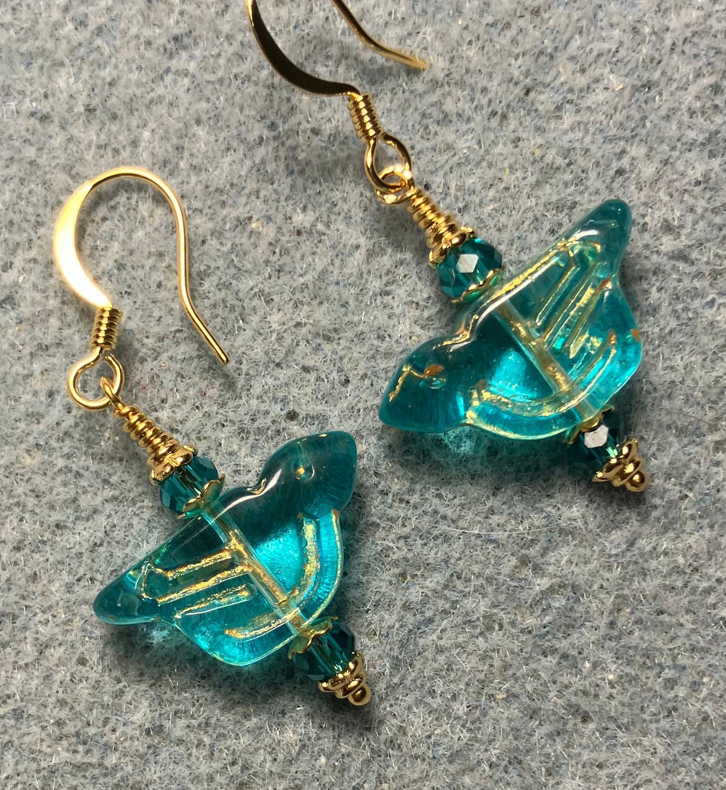 Translucent turquoise (with gold wash) Czech glass bird bead earrings adorned with turquoise Chinese crystal beads.
