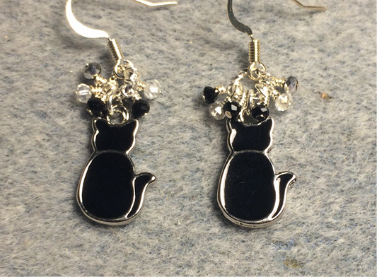 Small black enamel silhouette cat charm earrings adorned with tiny dangling black and silver beads.