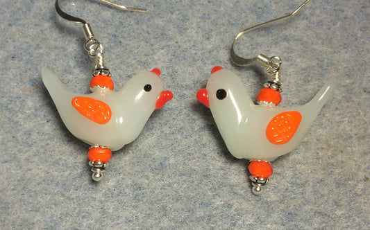 Milky white and orange lamp work songbird bead earrings adorned with orange Chinese crystal beads.