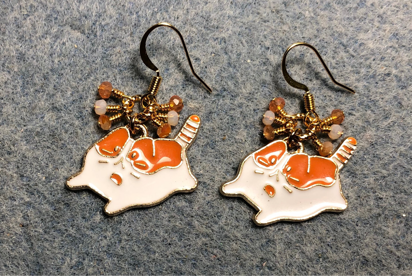 Orange and white enamel cat charm earrings adorned with tiny dangling orange and white Chinese crystal beads.