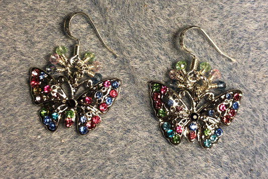 Silver, light blue, pink, and green rhinestone butterfly charm earrings adorned with tiny dangling light blue, pink, and green Chinese crystal beads.