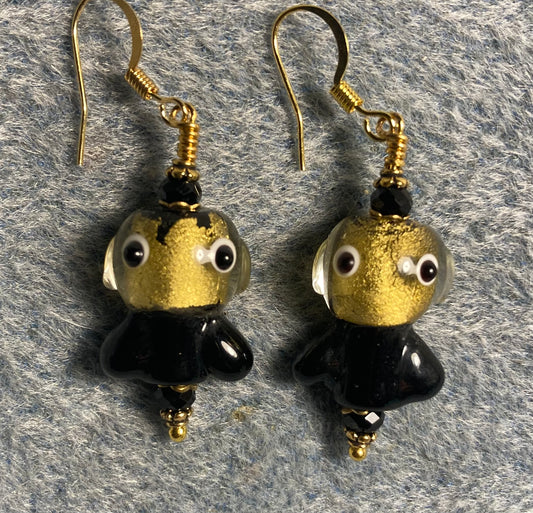 Black and gold lamp work fish bead earrings adorned with black Chinese crystal beads.