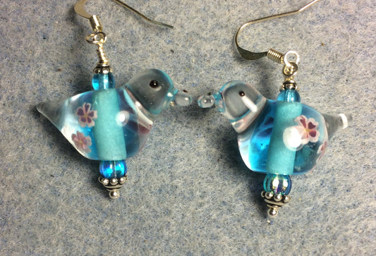 Translucent turquoise lamp work songbird bead earrings adorned with turquoise Czech glass beads.