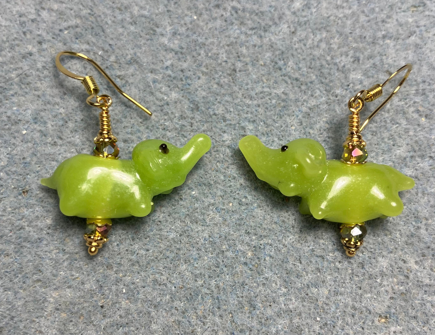 Small lime green lamp work elephant bead earrings adorned with sparkly lime green Chinese crystal beads.