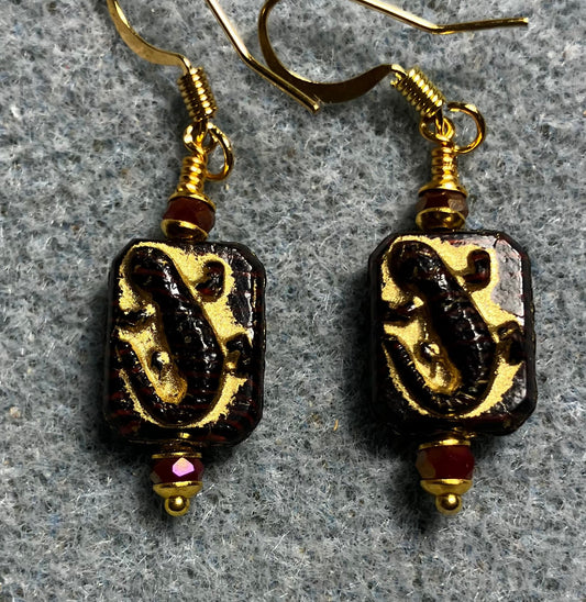 Small dark red and gold Czech glass lizard bead earrings adorned with dark red Chinese crystal beads.