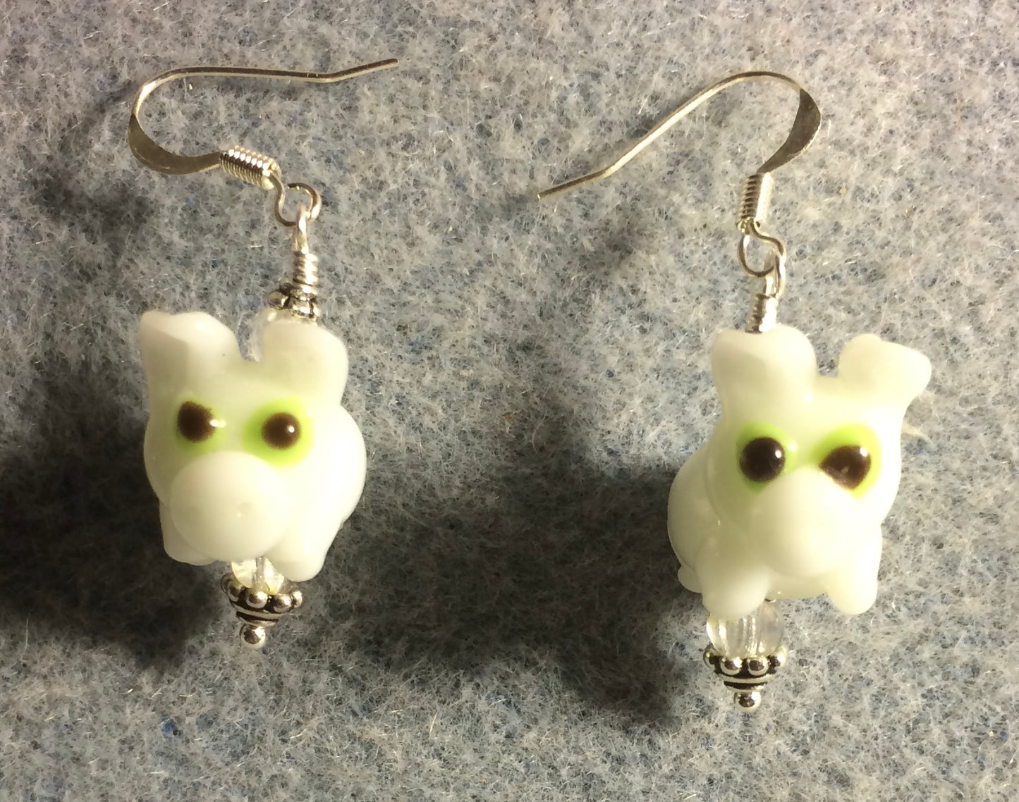 White lamp work pig bead earrings adorned with clear Czech glass beads.