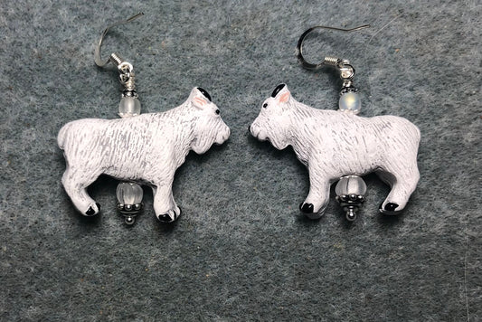 White ceramic goat bead earrings adorned with matte clear Czech glass beads.