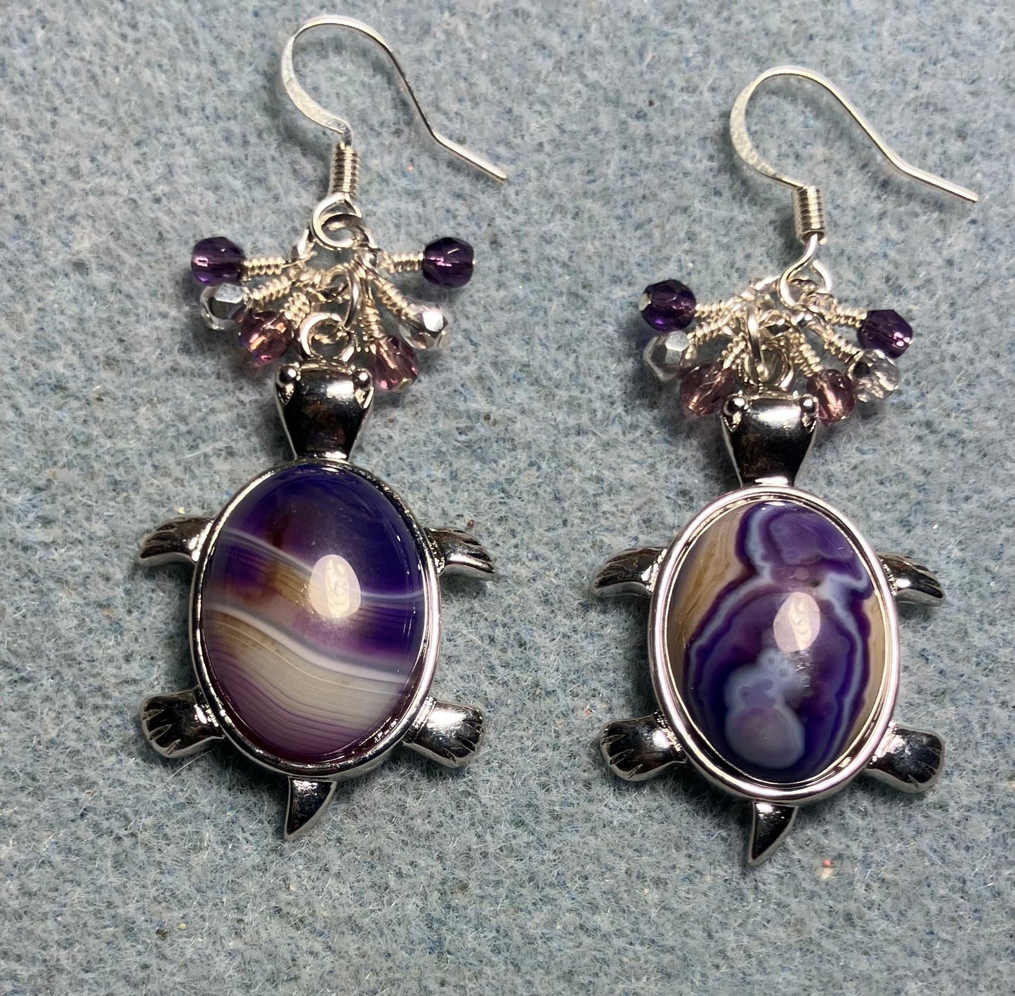 Large silver and purple agate gemstone turtle charm earrings adorned with small dangling purple and silver Czech glass beads.