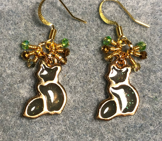 Green gray and gold sparkly resin cat charm earrings adorned with small dangling green, gold, and clear Chinese crystal beads.