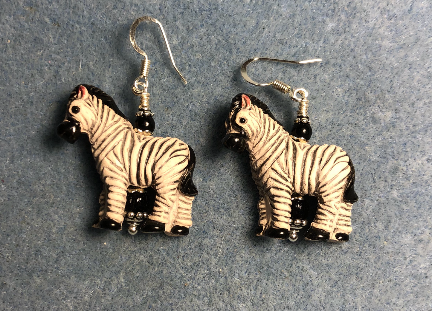 Black and white ceramic striped zebra bead earrings adorned with black Czech glass beads.