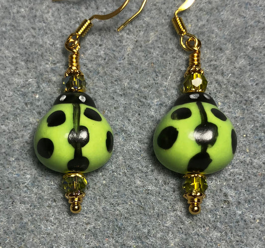 Lime green and black ceramic ladybug bead earrings adorned with lime green Chinese crystal beads.
