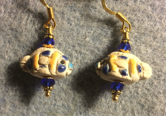 Small tan, dark blue, and yellow ceramic fish bead earrings adorned with dark blue Chinese crystal beads.