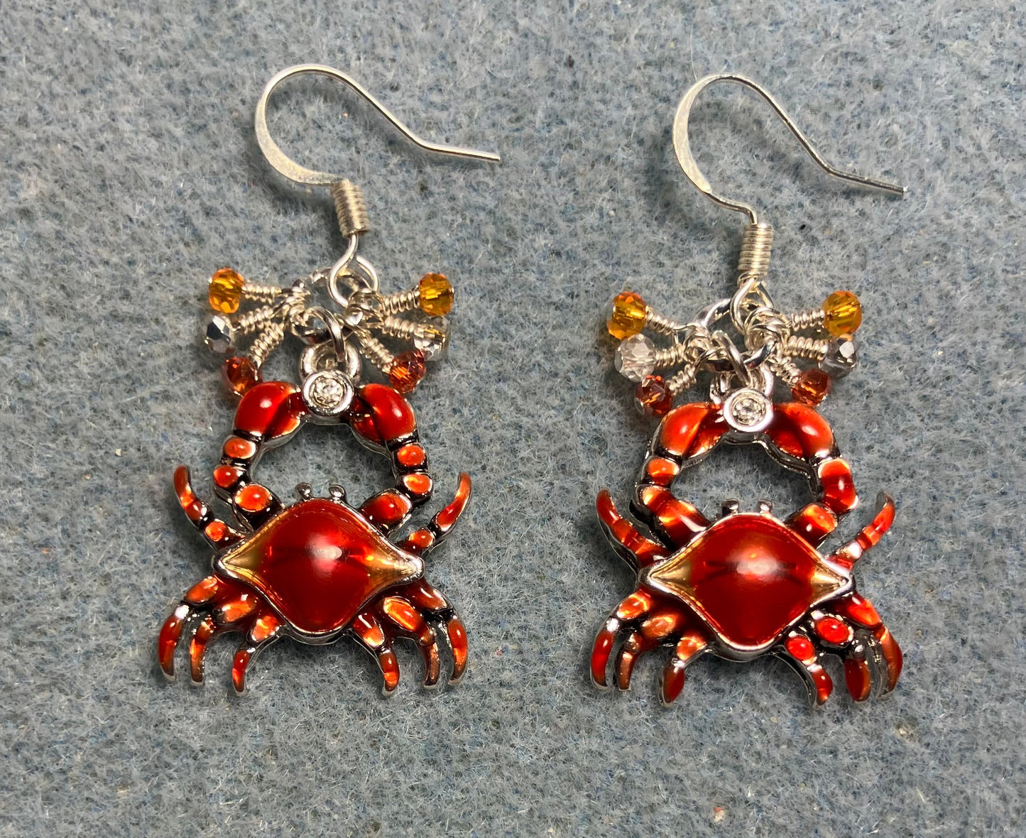 Dark orange enamel crab charm earrings adorned with tiny dangling dark orange, light orange, and silver Chinese crystal beads.