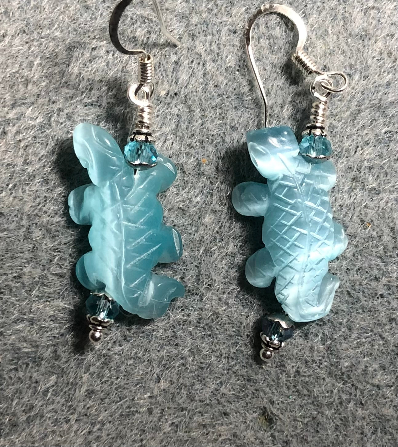 Turquoise fiber optic (cat’s eye) lizard bead earrings adorned with turquoise Chinese crystal beads.