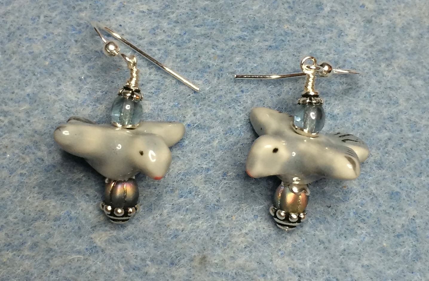 Blue gray ceramic flying bird bead earrings adorned with blue gray Czech glass beads.