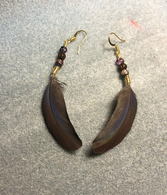 Bronze and purple Pionus parrot feather earrings adorned with small brown and purple Czech glass beads.