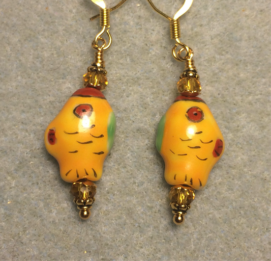 Small tangerine, red, and green ceramic fish bead earrings adorned with tangerine Chinese crystal beads.