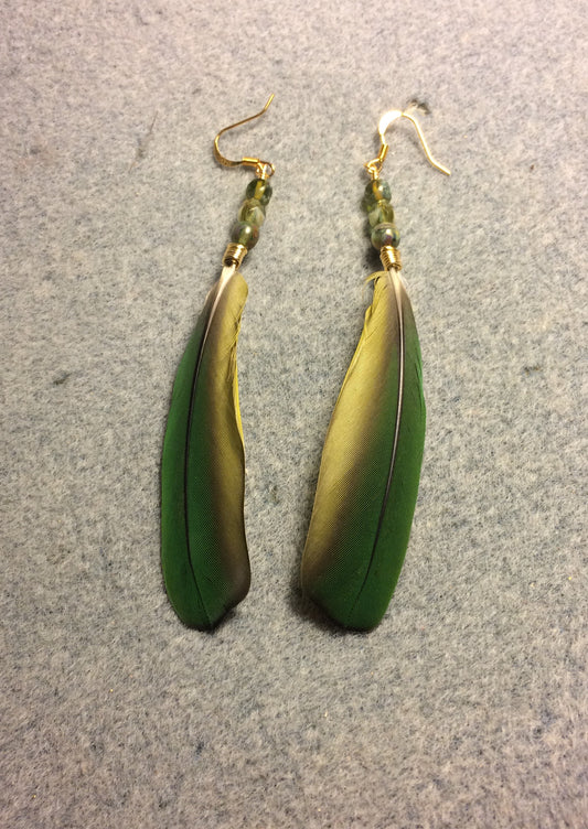 Green mini macaw feather earrings adorned with green Czech glass beads.