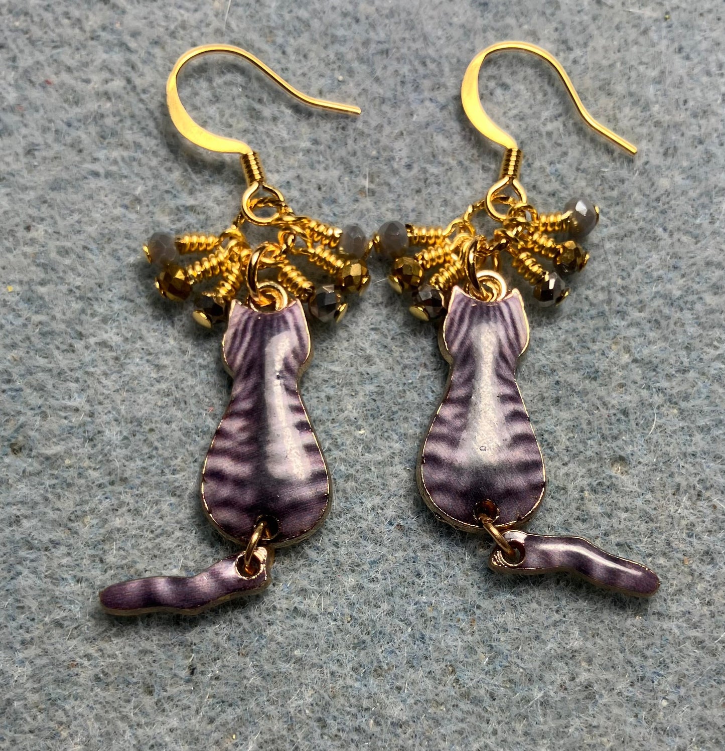 Gray and gold enamel tabby cat charm earrings adorned with tiny dangling gray and gold Chinese crystal beads.
